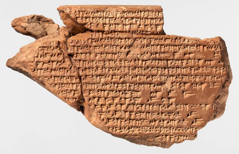 Irregular broken clay tablet fragment with cuneiform