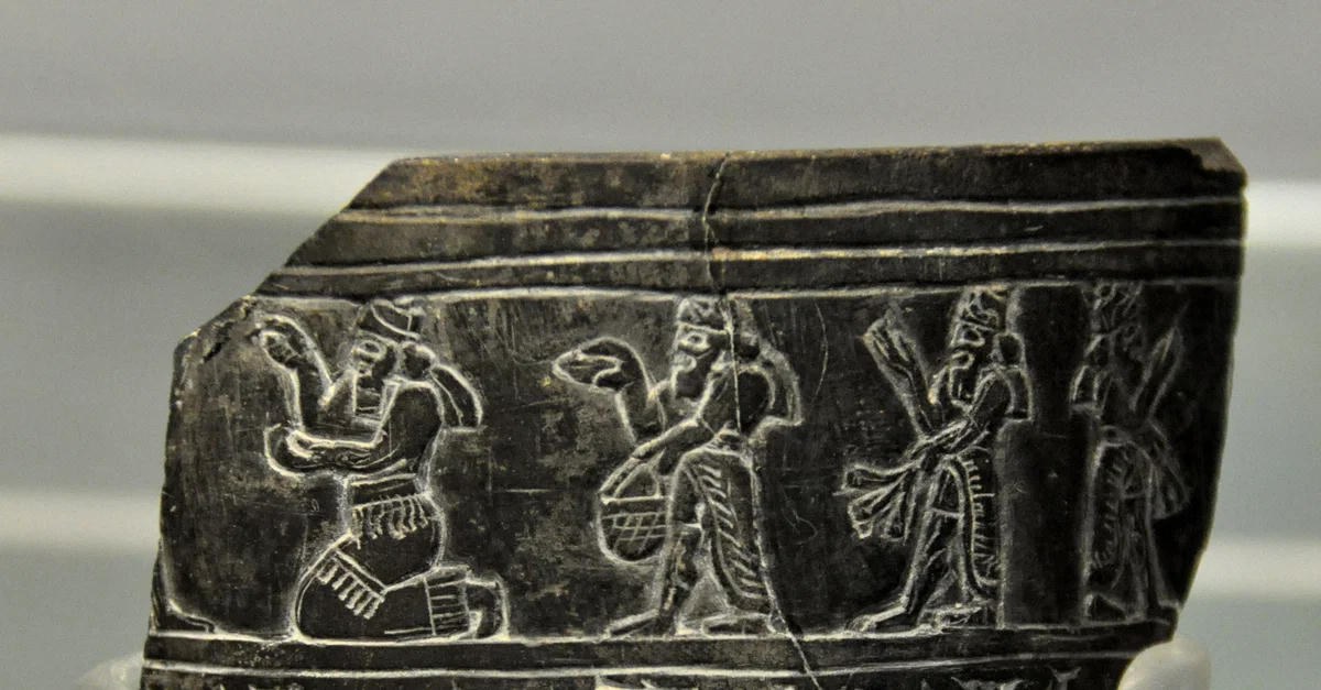 Dark stone cylinder seal impression with processional figures