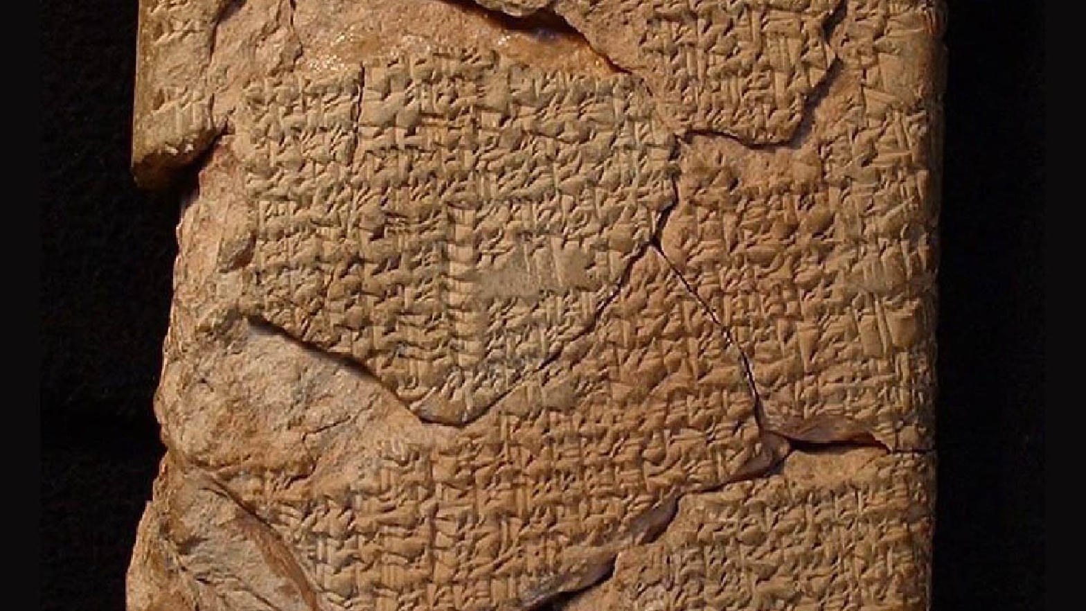 Close-up of a cracked cuneiform tablet with dense omen writing